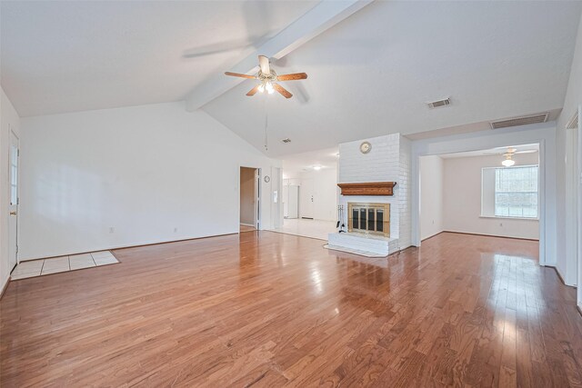 3626 Wells Mark Dr, Humble, TX 77396 - unfurnished living room featuring a ceiling fan, light wood-type flooring, and a fireplace