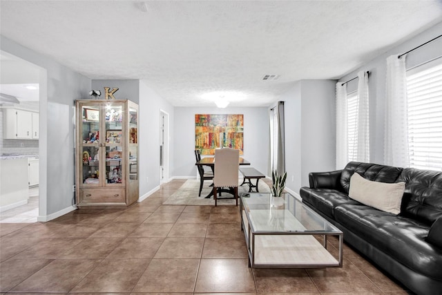 21426 Park York Dr, Katy, TX 77450 - living area with light tile patterned flooring and a textured ceiling