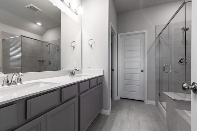 1202 Oak Barrel Run, Richmond, TX 77406 - full bath featuring a shower stall, double vanity, wood finished floors, and vaulted ceiling