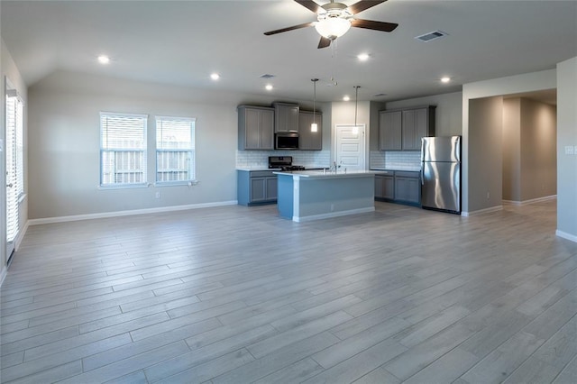1202 Oak Barrel Run, Richmond, TX 77406 - kitchen with stainless steel appliances, open floor plan, gray cabinets, a ceiling fan, and recessed lighting