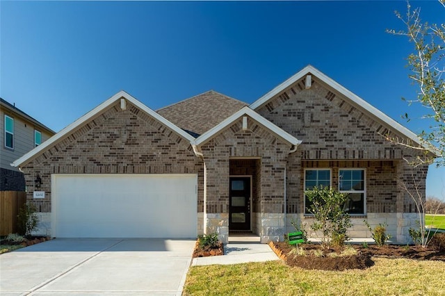 1202 Oak Barrel Run, Richmond, TX 77406 - view of front facade with an attached garage, concrete driveway, brick siding, roof with shingles, and stone siding