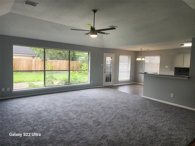 14119 Falling Elm Ln, Houston, TX 77015 - unfurnished living room featuring dark colored carpet, a chandelier, and ceiling fan