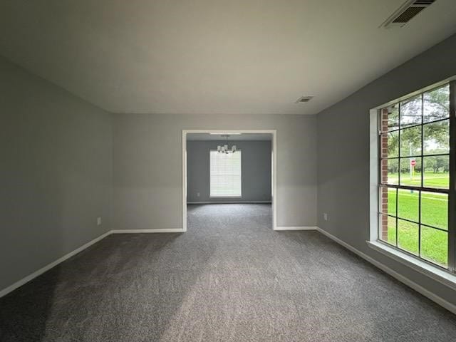 14119 Falling Elm Ln, Houston, TX 77015 - spare room with a chandelier, plenty of natural light, and dark carpet