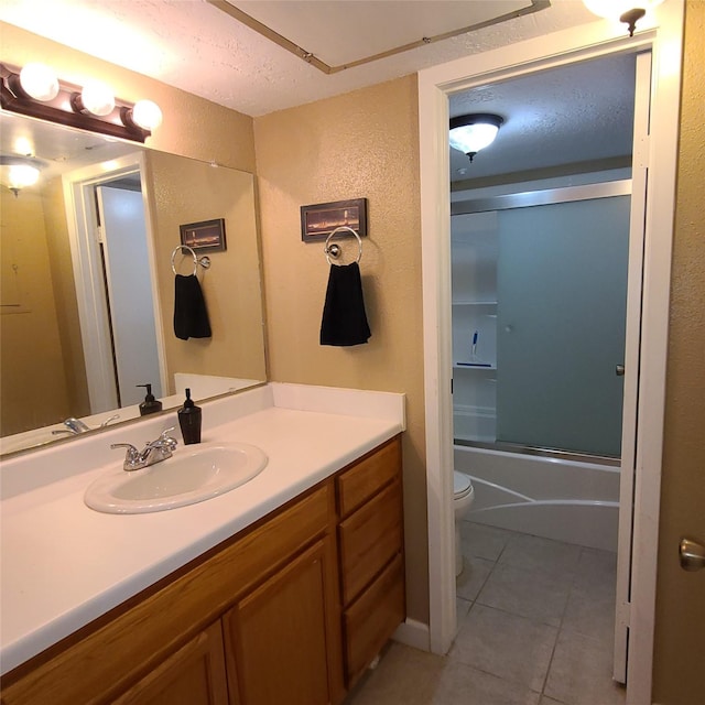 2011 Spenwick Dr Unit 220, Houston, TX 77055 - full bath featuring vanity, tile patterned flooring, a textured wall, and bath / shower combo with glass door