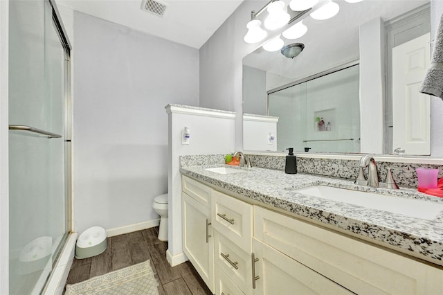 4358 Wildacres Dr, Houston, TX 77072 - full bath with a stall shower, double vanity, wood finished floors, and a baseboard radiator