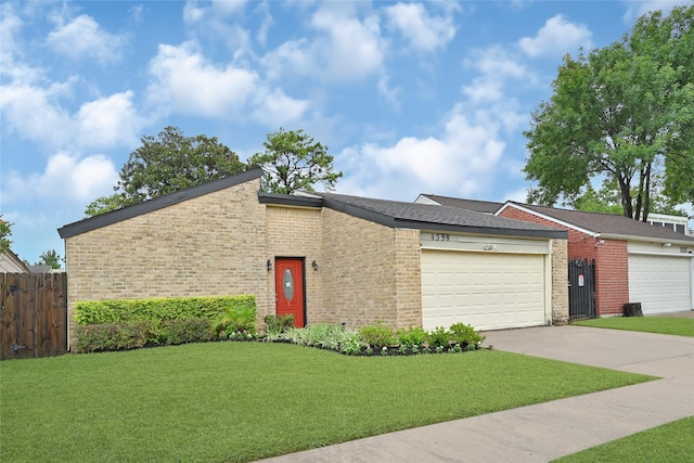 4358 Wildacres Dr, Houston, TX 77072 - view of front of home featuring a garage, brick siding, and driveway