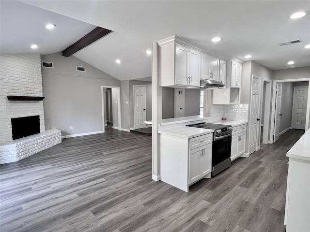 8826 Tanager St, Houston, TX 77036 - kitchen with stainless steel electric stove, under cabinet range hood, white cabinets, light countertops, and dark wood finished floors