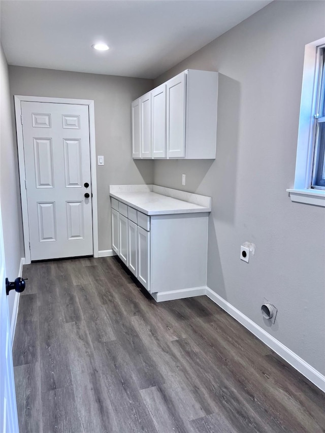 8826 Tanager St, Houston, TX 77036 - washroom with electric dryer hookup, dark wood-style flooring, cabinet space, and recessed lighting