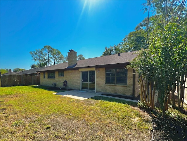 8826 Tanager St, Houston, TX 77036 - back of property featuring a patio, brick siding, and a chimney