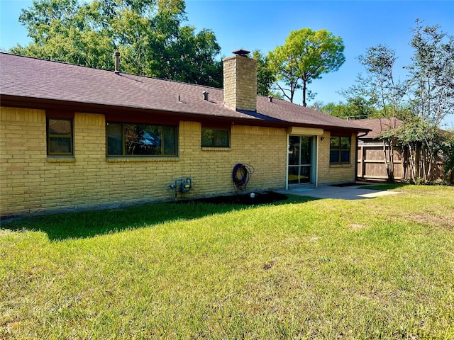 8826 Tanager St, Houston, TX 77036 - back of house with a chimney, brick siding, and a shingled roof