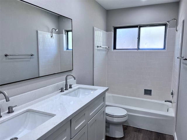 8826 Tanager St, Houston, TX 77036 - bathroom with wood finished floors, washtub / shower combination, and double vanity
