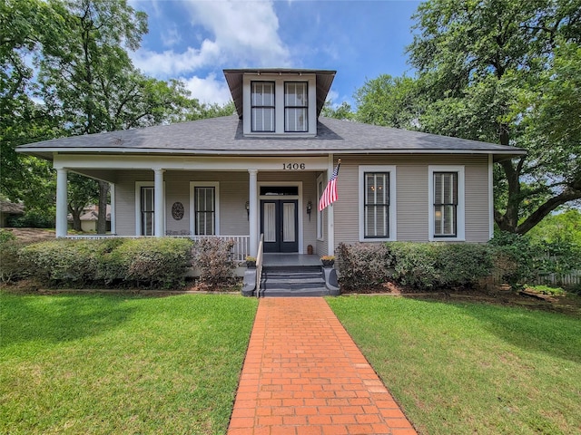 1406 Key St, Brenham, TX 77833 - view of front facade with a front yard, a porch, and a shingled roof