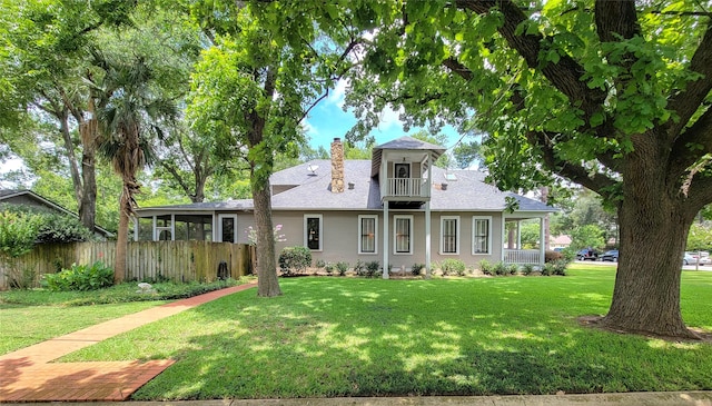 1406 Key St, Brenham, TX 77833 - view of front facade with a chimney, roof with shingles, and a balcony