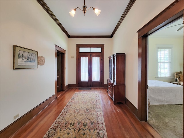 1406 Key St, Brenham, TX 77833 - foyer with a chandelier, wood finished floors, and crown molding