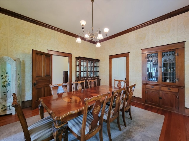 1406 Key St, Brenham, TX 77833 - dining space with ornamental molding, dark wood-style flooring, and a chandelier