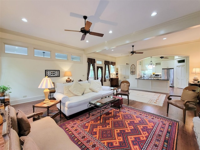 1406 Key St, Brenham, TX 77833 - living room featuring a ceiling fan, ornamental molding, dark wood-style flooring, recessed lighting, and arched walkways
