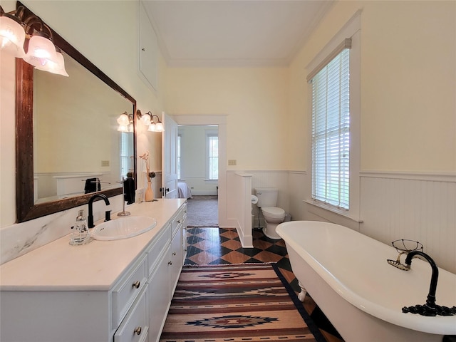 1406 Key St, Brenham, TX 77833 - full bathroom with a wainscoted wall, a soaking tub, vanity, ornamental molding, and tile patterned floors