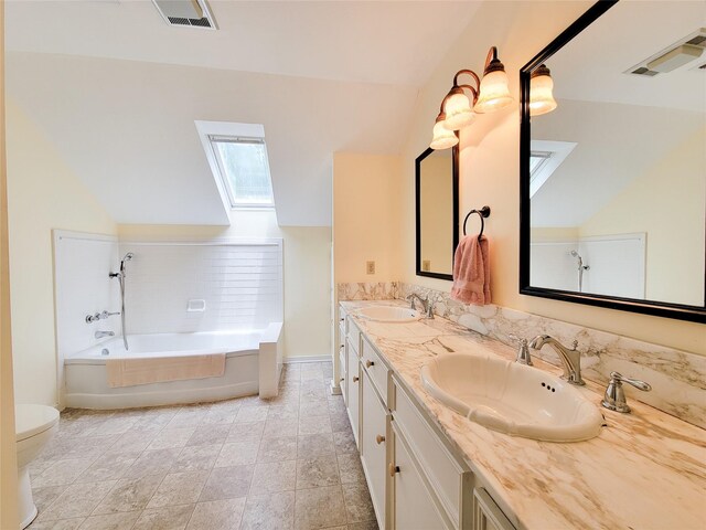1406 Key St, Brenham, TX 77833 - bathroom with a skylight, a bath, double vanity, and lofted ceiling