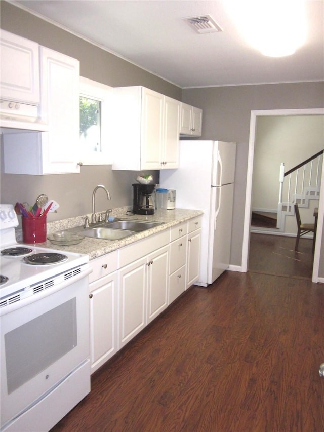 1406 Key St, Brenham, TX 77833 - kitchen featuring white appliances, range hood, white cabinets, and light countertops