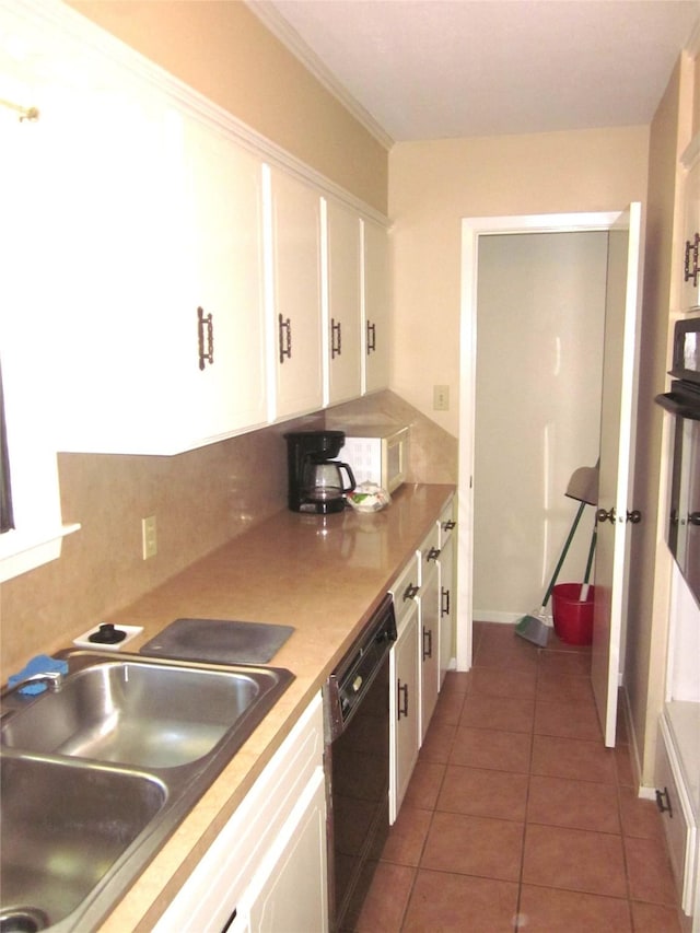 1406 Key St, Brenham, TX 77833 - kitchen featuring dishwasher, white cabinetry, tile patterned floors, and light countertops
