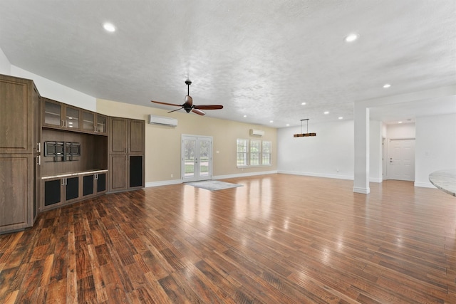 43919 Austin Branch Rd, Hempstead, TX 77445 - unfurnished living room featuring a ceiling fan, recessed lighting, a wall unit AC, dark wood-style flooring, and a wall mounted AC