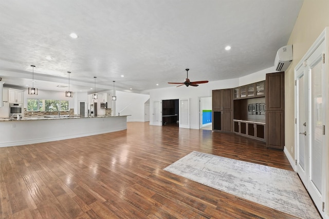 43919 Austin Branch Rd, Hempstead, TX 77445 - unfurnished living room featuring recessed lighting, dark wood-style flooring, a ceiling fan, and a wall mounted AC