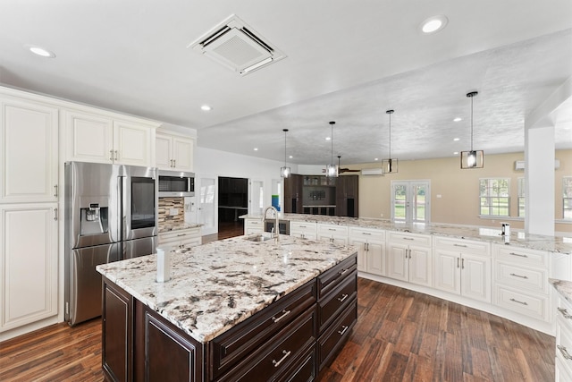 43919 Austin Branch Rd, Hempstead, TX 77445 - kitchen featuring stainless steel appliances, dark wood-style floors, white cabinets, and recessed lighting