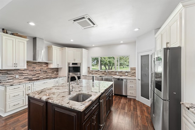 43919 Austin Branch Rd, Hempstead, TX 77445 - kitchen with appliances with stainless steel finishes, wall chimney exhaust hood, decorative backsplash, dark wood-type flooring, and recessed lighting