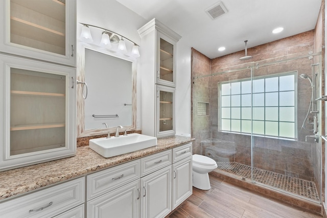 43919 Austin Branch Rd, Hempstead, TX 77445 - full bathroom featuring vanity, a stall shower, and wood finished floors