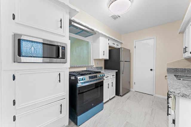 9403 Rentur Dr, Houston, TX 77031 - kitchen with stainless steel appliances, white cabinets, light stone countertops, and exhaust hood