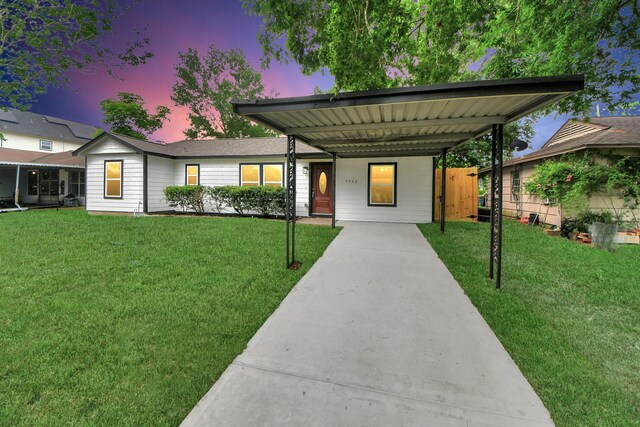 5722 Beldart St, Houston, TX 77033 - view of front of property featuring a front lawn, driveway, and an attached carport