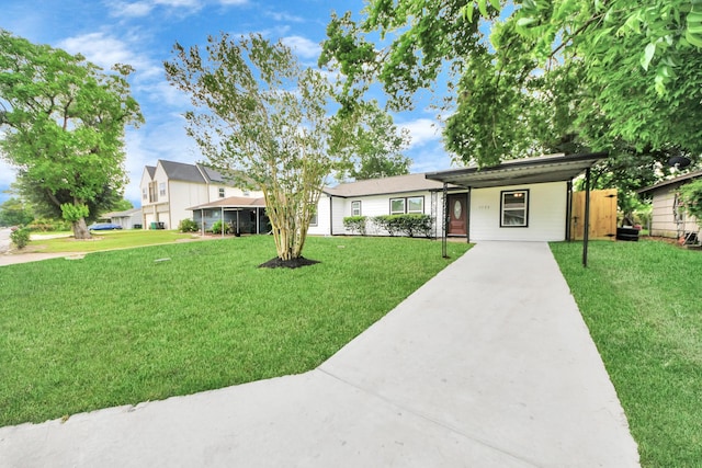 5722 Beldart St, Houston, TX 77033 - ranch-style home with driveway, a front lawn, and an attached carport