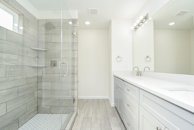2807 Pine Estate Ln, Houston, TX 77014 - bathroom with double vanity, a shower stall, and recessed lighting