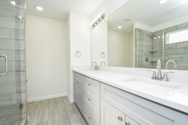 2807 Pine Estate Ln, Houston, TX 77014 - bathroom with double vanity, a stall shower, and recessed lighting