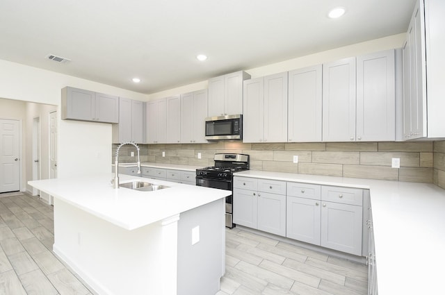 2807 Pine Estate Ln, Houston, TX 77014 - kitchen with stainless steel appliances, tasteful backsplash, wood tiled floors, light countertops, and recessed lighting