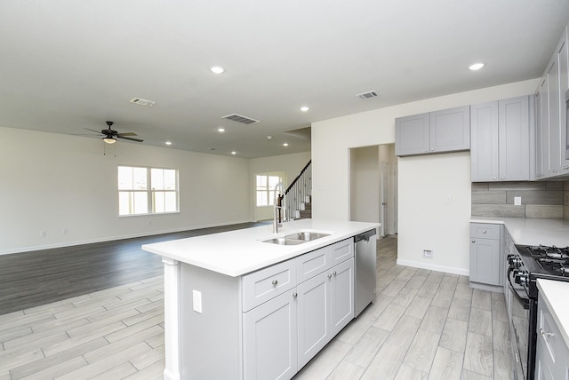 2807 Pine Estate Ln, Houston, TX 77014 - kitchen featuring black range with gas cooktop, dishwasher, light wood-type flooring, a ceiling fan, and recessed lighting