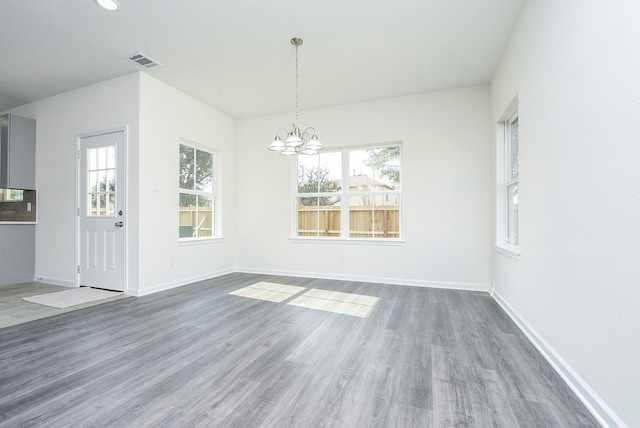 2807 Pine Estate Ln, Houston, TX 77014 - unfurnished dining area with a chandelier and wood finished floors