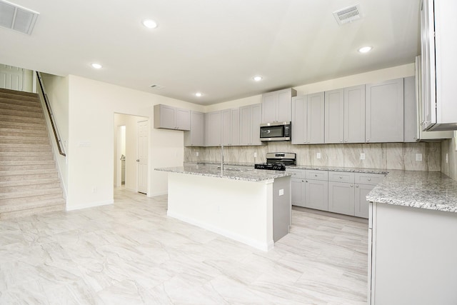 2807 Pine Estate Ln, Houston, TX 77014 - kitchen with appliances with stainless steel finishes, gray cabinetry, tasteful backsplash, light stone countertops, and recessed lighting
