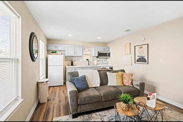 3801 Anita St, Houston, TX 77004 - living area with light wood-style flooring and recessed lighting