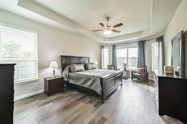 1638 Dominion Heights Ln, Katy, TX 77423 - bedroom with a raised ceiling, wood finished floors, and ceiling fan