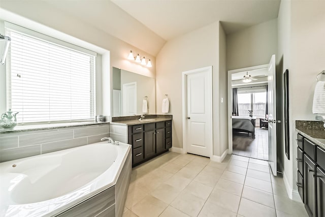 1638 Dominion Heights Ln, Katy, TX 77423 - full bathroom featuring ensuite bathroom, vanity, a garden tub, vaulted ceiling, and tile patterned floors