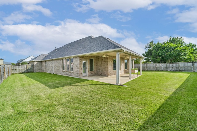 1638 Dominion Heights Ln, Katy, TX 77423 - back of property with a ceiling fan, brick siding, a shingled roof, a fenced backyard, and a patio area