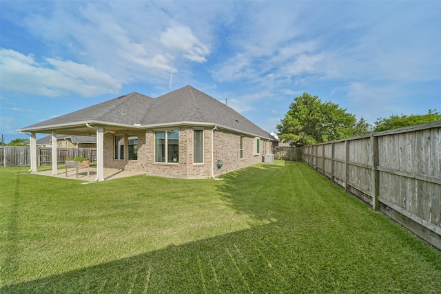 1638 Dominion Heights Ln, Katy, TX 77423 - back of property featuring a patio area, brick siding, a fenced backyard, and roof with shingles
