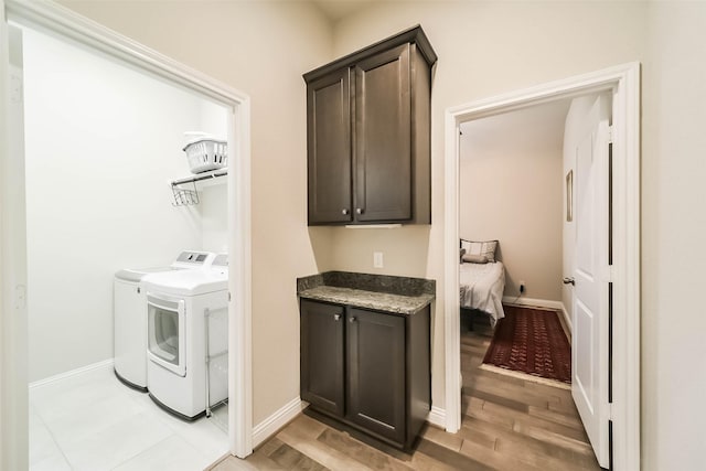 1638 Dominion Heights Ln, Katy, TX 77423 - laundry room with washer and dryer, cabinet space, and light wood-style floors