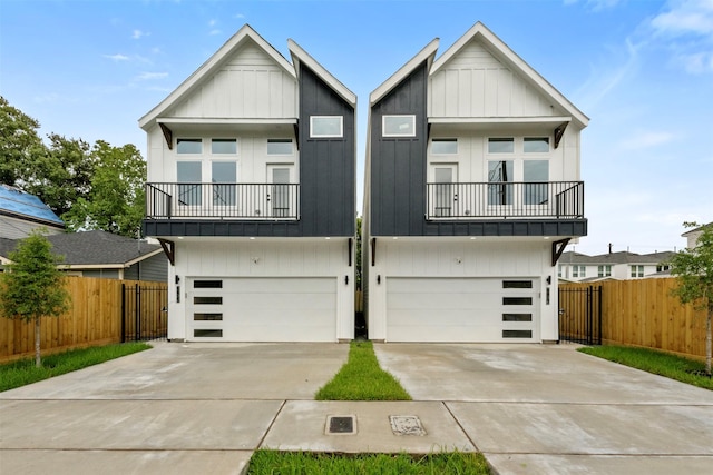 6815 Paris St, Houston, TX 77021 - view of front of property featuring a balcony, concrete driveway, an attached garage, and board and batten siding