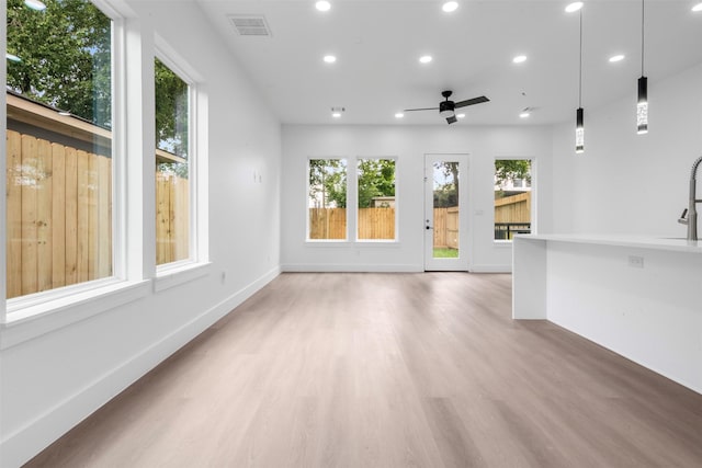 6815 Paris St, Houston, TX 77021 - unfurnished living room with recessed lighting, light wood-style floors, and ceiling fan