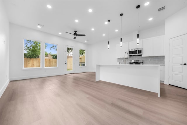 6815 Paris St, Houston, TX 77021 - unfurnished living room with light wood-type flooring, recessed lighting, and ceiling fan
