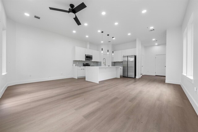 6815 Paris St, Houston, TX 77021 - unfurnished living room with ceiling fan, recessed lighting, and light wood-type flooring