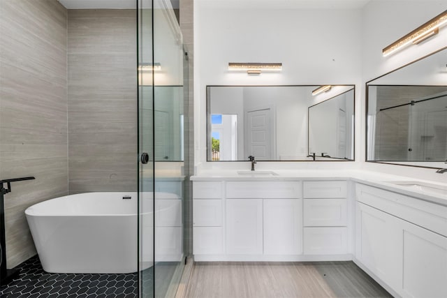 6815 Paris St, Houston, TX 77021 - full bathroom featuring double vanity, a freestanding bath, and a shower stall
