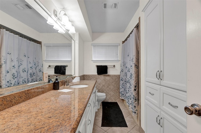 2010 Oceanview Dr, Seabrook, TX 77586 - bathroom with tile patterned floors, vanity, tile walls, wainscoting, and a shower with shower curtain